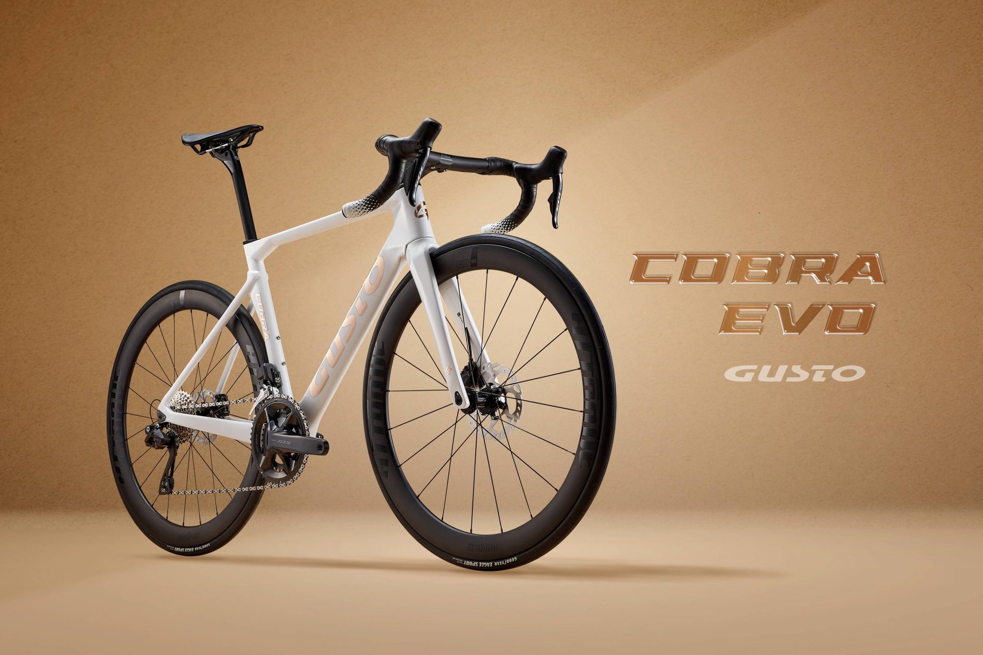 White bicycle with black details on a beige background, featuring 'Cobra Evo Gusto' branding.