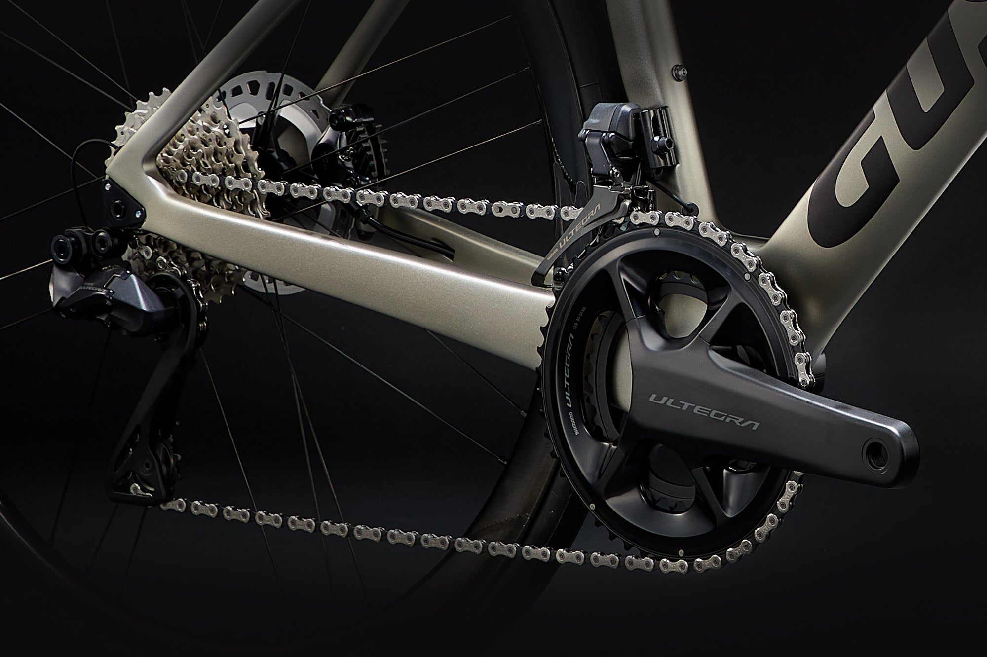 Close-up of a bicycle chain and gear system with 'Giant' branding on a black background