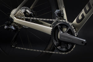 Close-up of a bicycle chain and gear system with 'Giant' branding on a black background