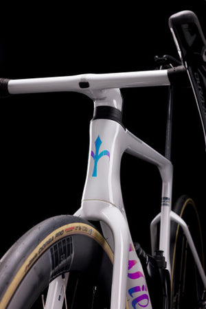 White bicycle frame with colorful design on a black background