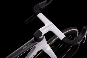 Close-up of a bicycle frame with handlebars on a black background