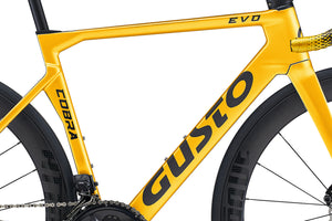 Yellow bicycle frame with 'Cobra' and 'Gusto' branding on a white background