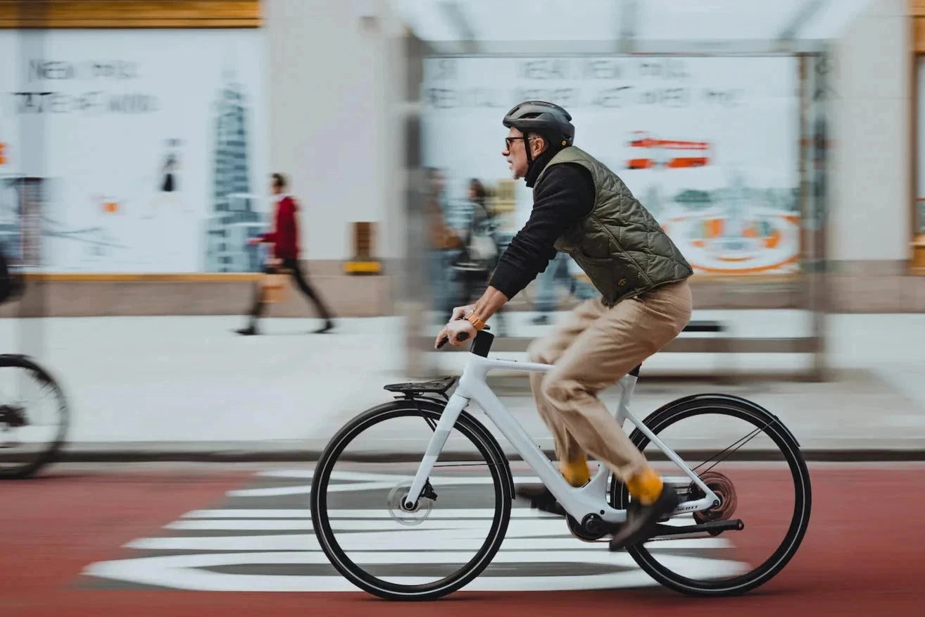 Person riding a bicycle on a city street with blurred background